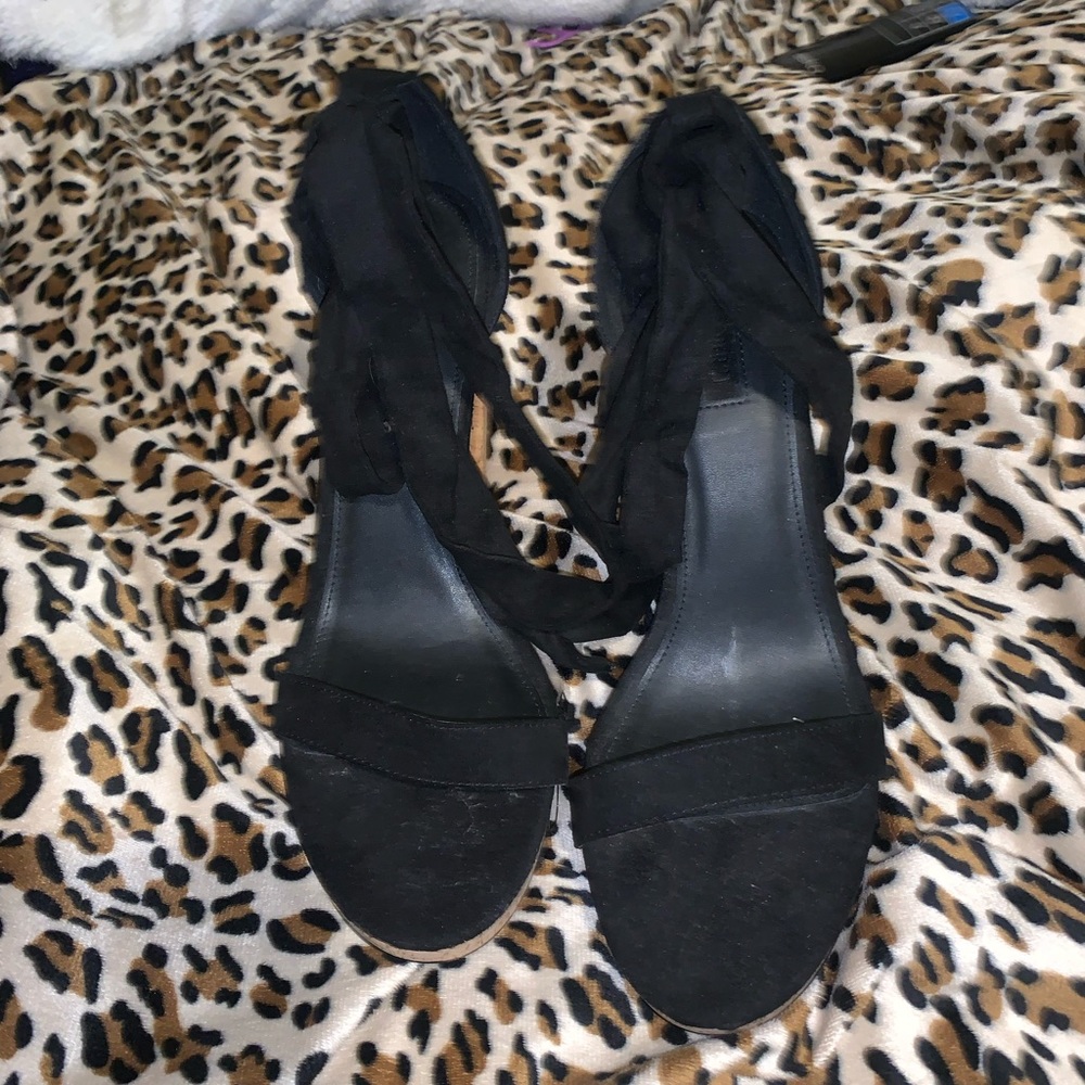 Black tie up heel. Cork heel. Never been worn.